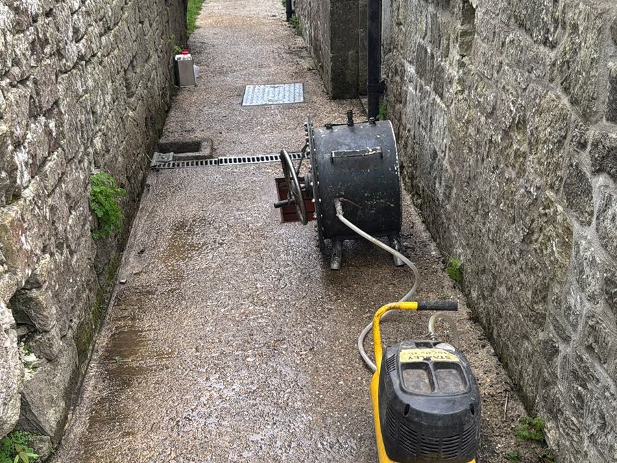 Jetting equipment working a rear alley drainage run